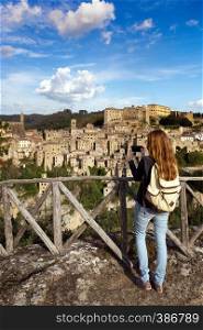 girl making a photo shoot of old city sorano, italy