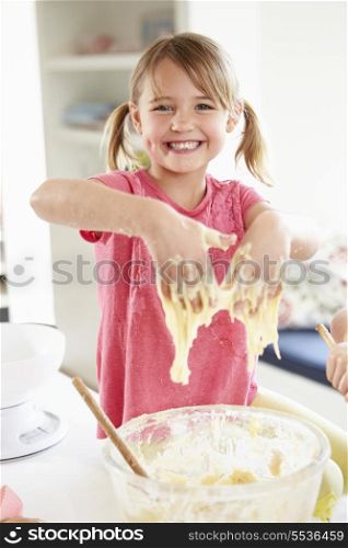Girl Making Cupcakes In Kitchen