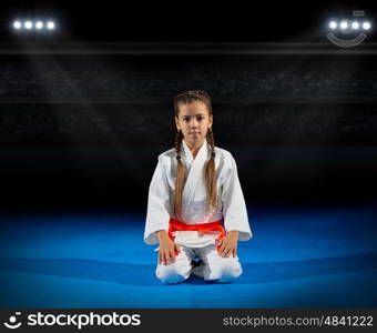 Girl martial arts fighter at sports hall