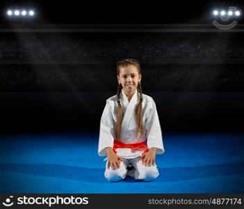 Girl martial arts fighter in sports hall