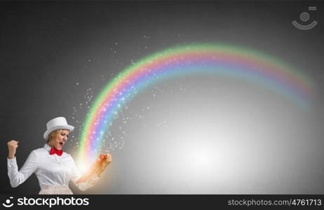 Girl mastering science. Young emotional woman in white cylinder with book in hand