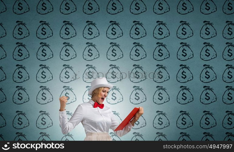 Girl mastering science. Young emotional woman in white cylinder with book in hand