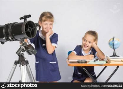 Girl mysteriously astronomer looks into the distance, a classmate with a smile looked at her