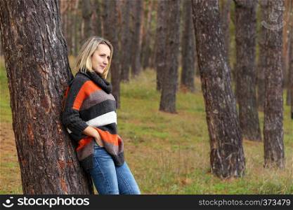 girl near a tree in a pine forest