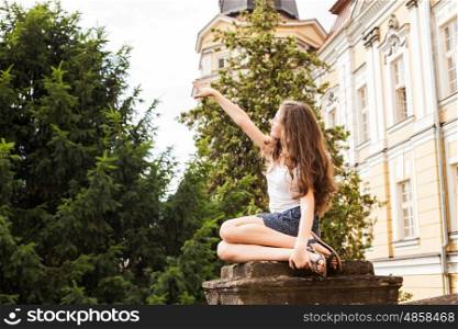 Girl near the hight school building. Education concept, end of school. Summer holidays