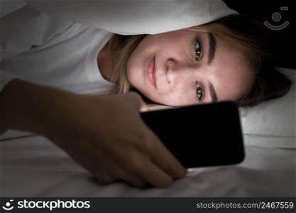 girl night bed with phone close up