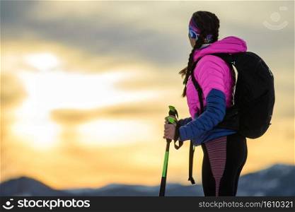 Girl observes the breathtaking sky during a winter alpine trek