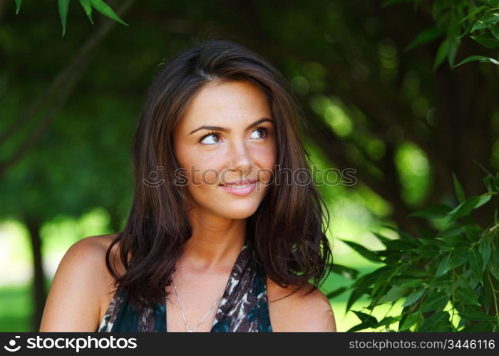 girl on a background of green trees