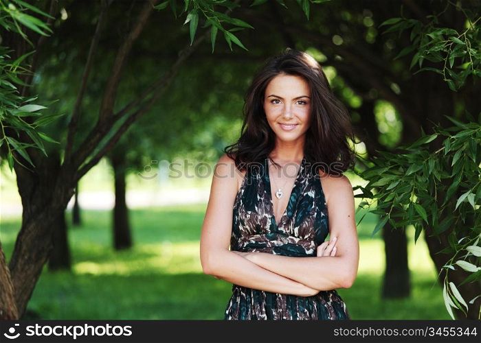 girl on a background of green trees