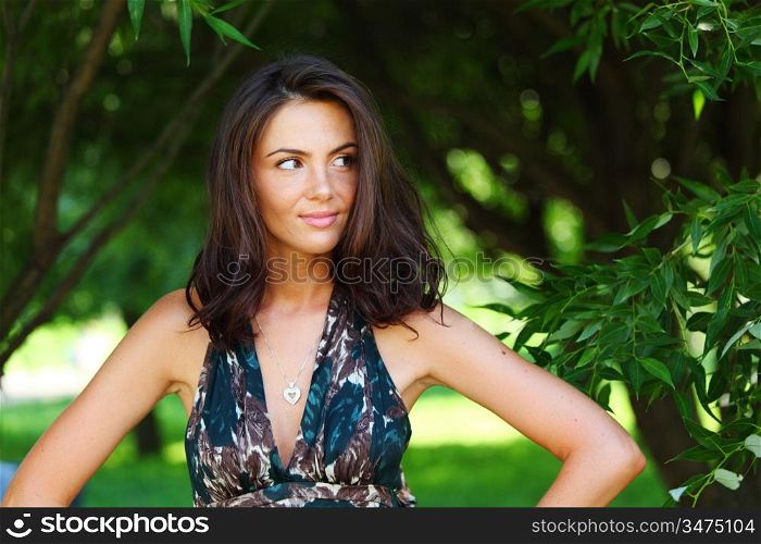 girl on a background of green trees