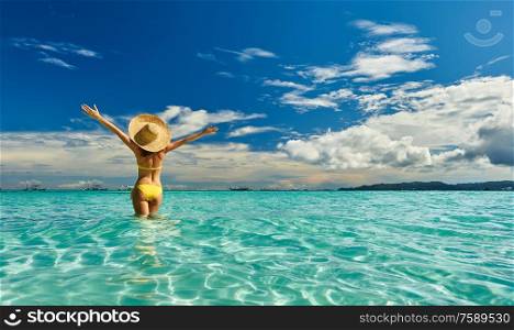 Girl on a tropical beach at Philippines with outstretched arms