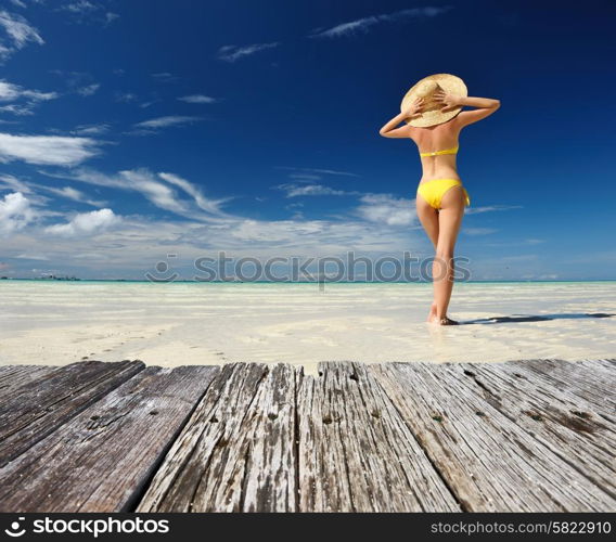 Girl on a tropical beach with hat