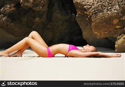 Girl on a tropical rocky beach