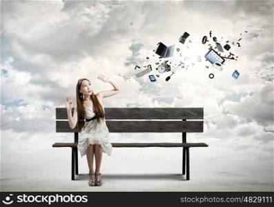 Girl on bench. Young pretty scared asian woman sitting on bench