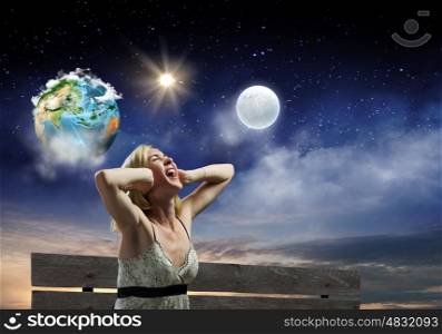 Girl on bench. Young woman sitting on bench closing ears with palms and screaming. Elements of this image are furnished by NASA