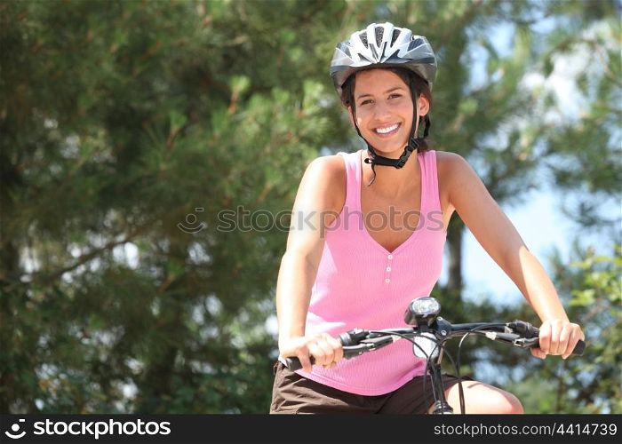 Girl on bicycle with helmet