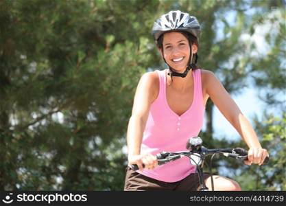 Girl on bicycle with helmet