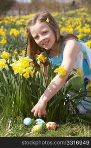 Girl On Easter Egg Hunt In Daffodil Field