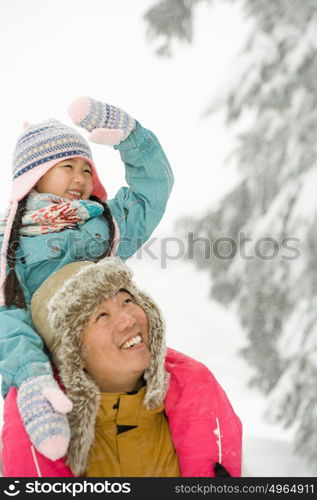 Girl on fathers shoulders