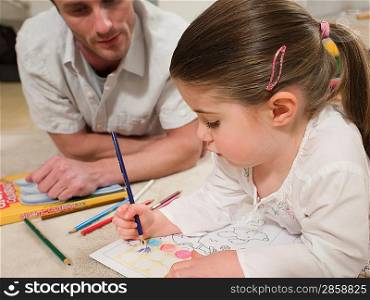Girl on Floor Coloring With Father