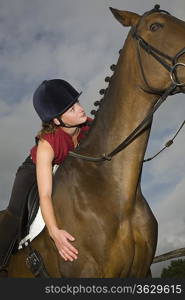 Girl on horseback, low angle view