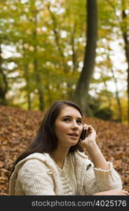 girl on phone in woods
