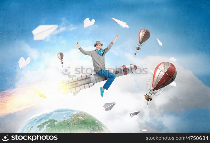 Girl on rocket. Young cheerful girl riding on rocket high in sky. Elements of this image are furnished by NASA
