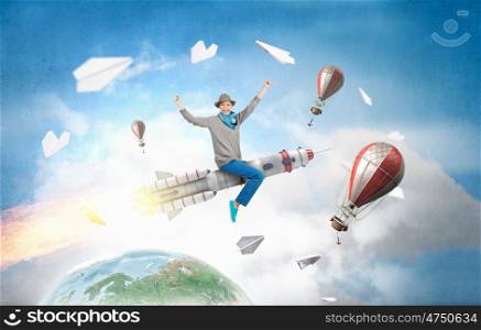 Girl on rocket. Young cheerful girl riding on rocket high in sky. Elements of this image are furnished by NASA