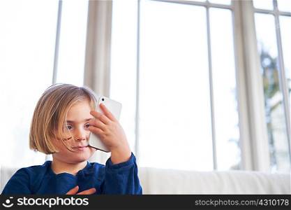 Girl on sofa using smartphone