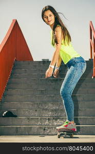 Girl on stairs with skateboard.. Cool skate young long haired girl riding skateboard on the urban stairs. Active lifestyle funky in summer. Outdoor trendy sport teen.