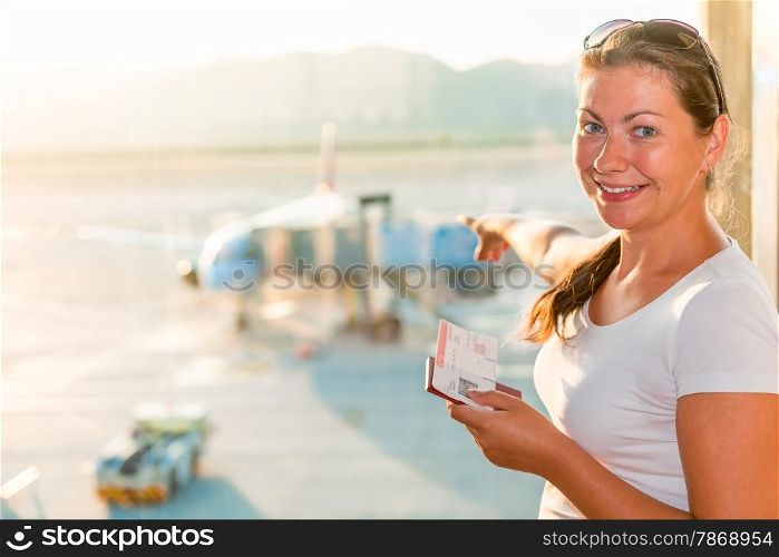 girl on the background plane at the airport