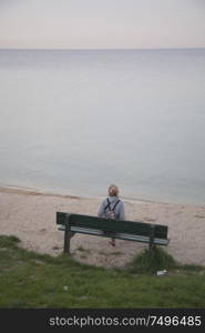 girl on the beach at sunset. Relax by the water