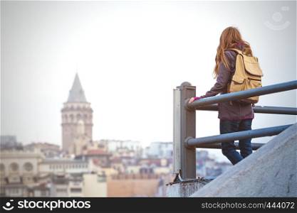 girl on the observation deck looks at Istanbul. Mosque in the background