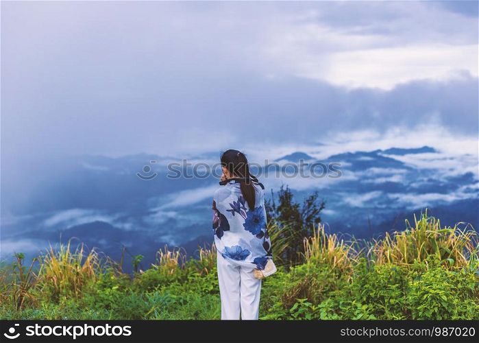 Girl on the top hill while take a photo view in the morning.