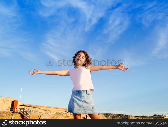 Girl open arms outdoor under blue sky with happy gesture