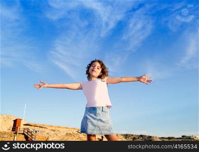 Girl open arms outdoor under blue sky with happy gesture