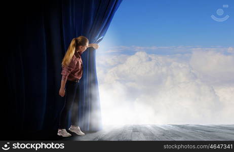 Girl opening curtain. Young woman in casual opening drape curtain