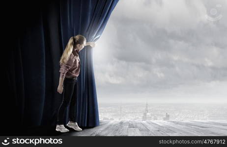 Girl opening curtain. Young woman in casual opening drape curtain