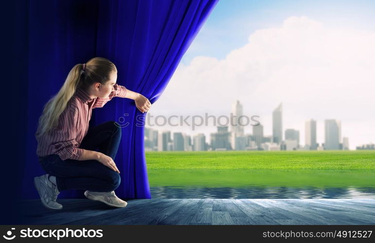 Girl opening curtain. Young woman in casual opening drape curtain