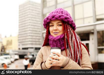 Girl outdoor holding a cup of coffee during a cold weather