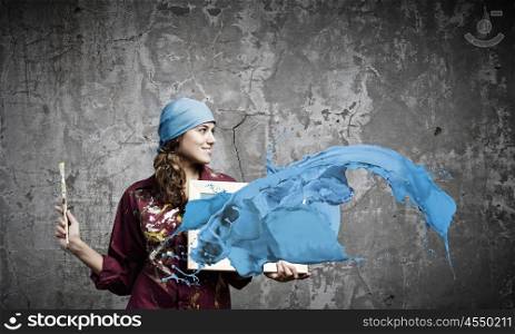 Girl painter. Young woman painter holding frame with colorful splashes