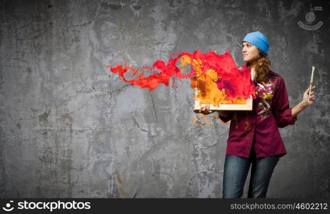 Girl painter. Young woman painter holding frame with colorful splashes