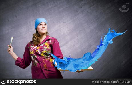 Girl painter. Young woman painter holding frame with colorful splashes