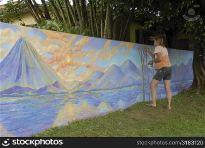 Girl painting mural