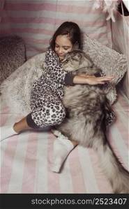 girl pajamas cat hugging