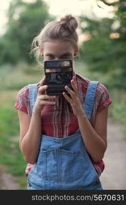 Girl photographer and instant camera