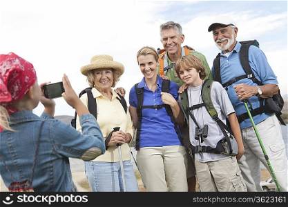 Girl photographing family portrait