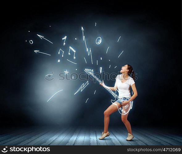 Girl play guitar. Young pretty girl in shorts and shirt playing imaginary guitar