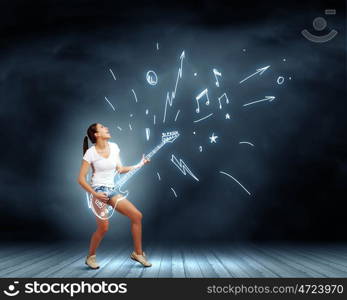 Girl play guitar. Young pretty girl in shorts and shirt playing imaginary guitar