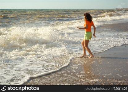 Girl play on the beach. Emotional scene.